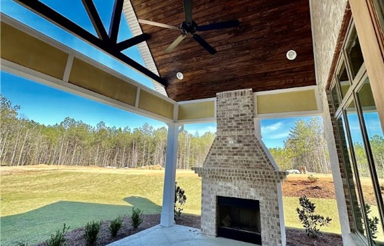 An Exterior Fireplace On The Vaulted Covered Porch